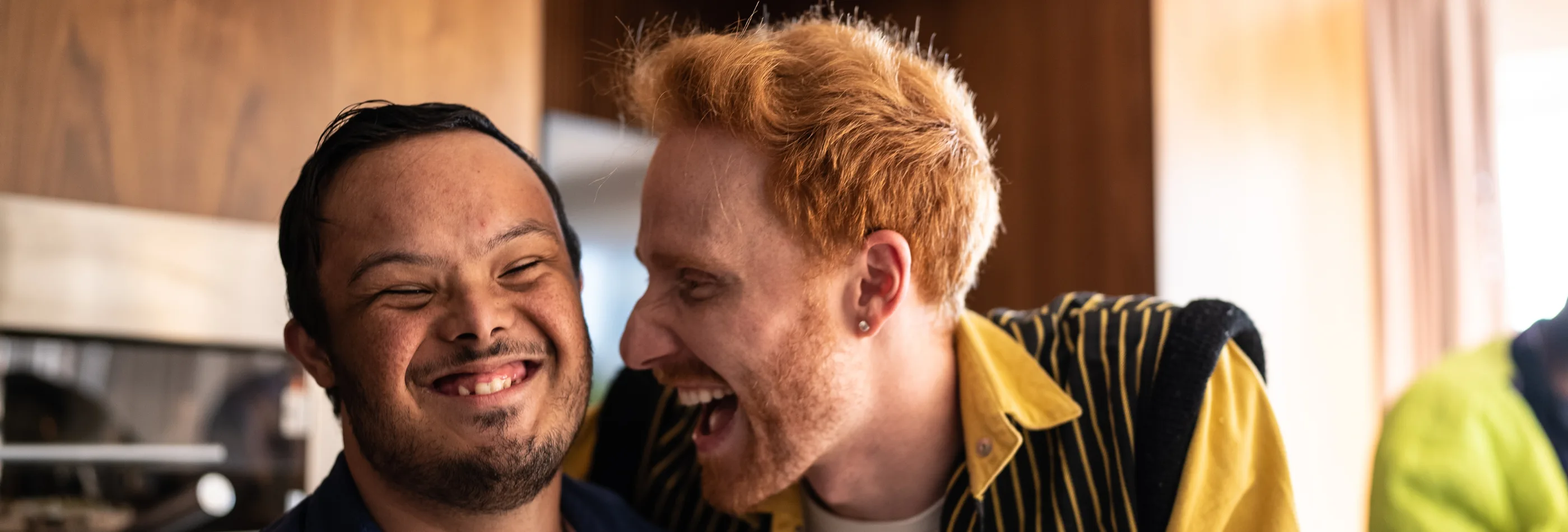 Man with Downs Syndrome and friend laughing