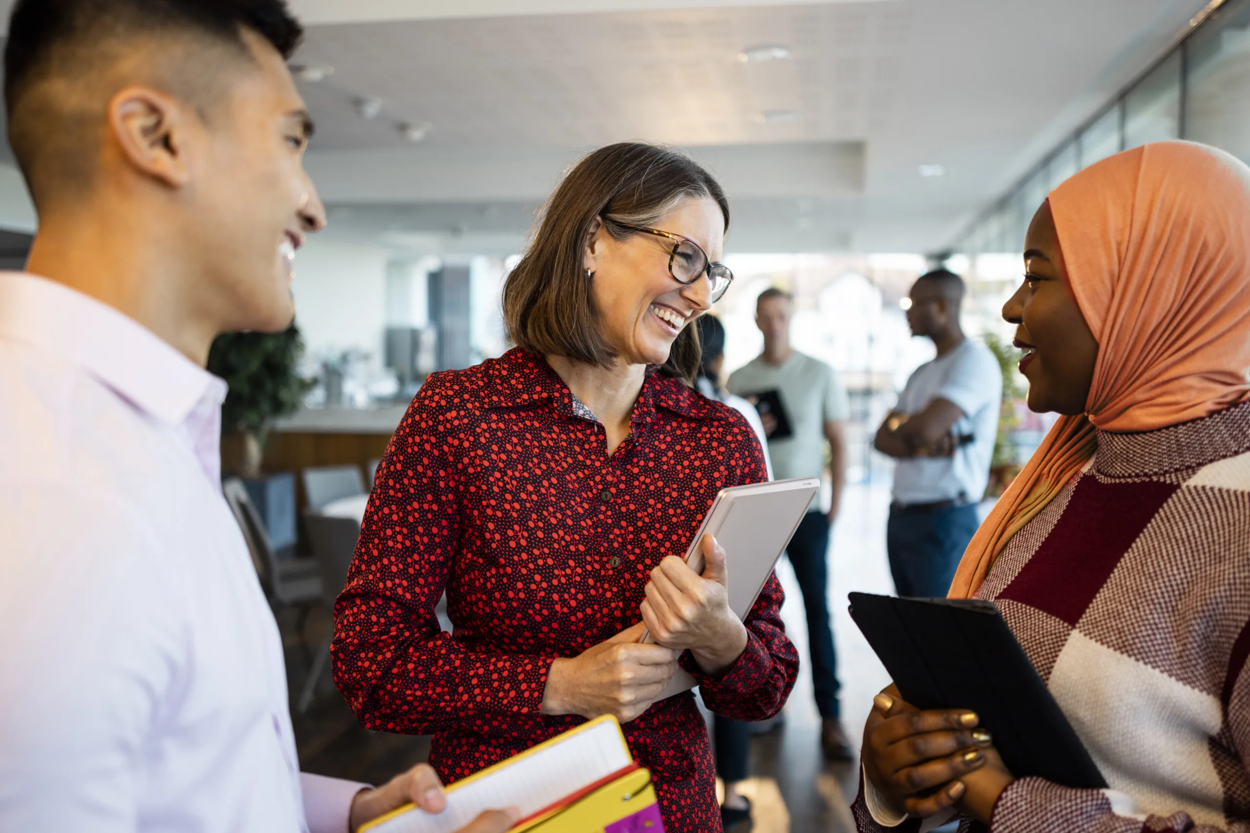 Three people talking at a networking event