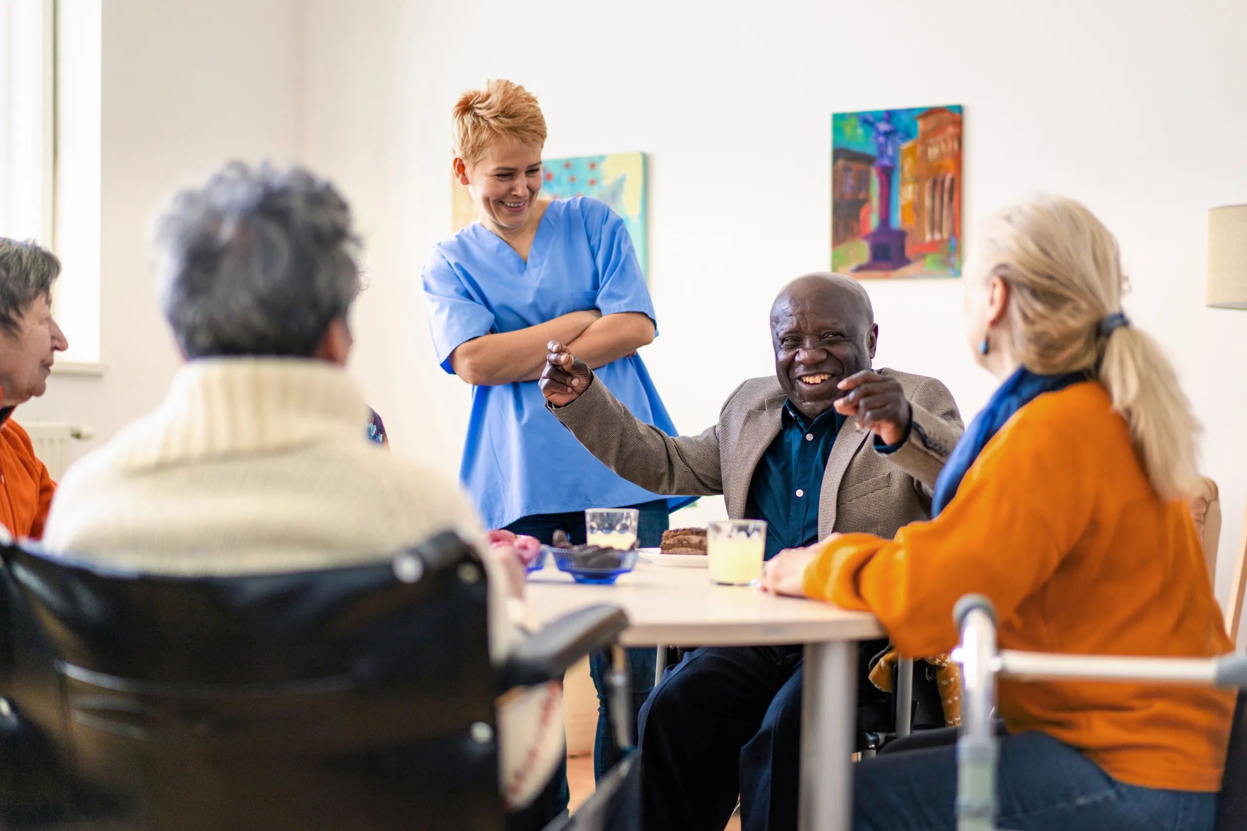 Healthcare professional talking to residents at care home